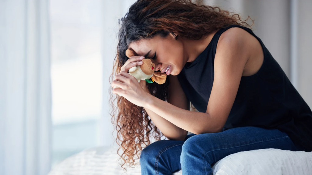 woman crying her hearts out as she remembers all her traumatic past